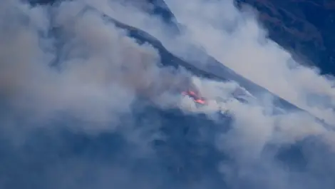 FENZ responding to vegetation fire on Walter Peak, smoke visible from Queenstown